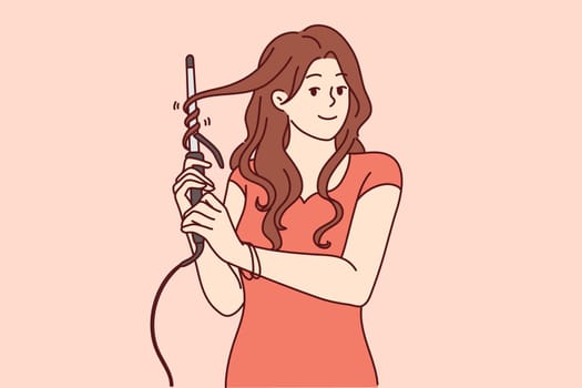 Woman uses electric curling iron to get curly hairstyle and get ready for party or date with boyfriend. Girl with curling iron wants to become beautiful giving straight hair curly look