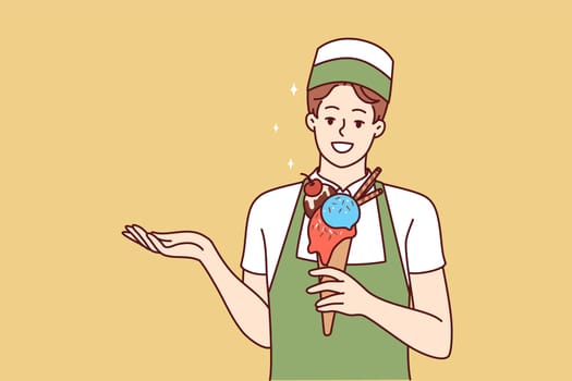 Woman ice cream seller holds cold dessert in waffle cup offering fruit delicacy to refresh after walk. Girl waiter in apron demonstrates ice cream to satisfy hunger in hot summer weather