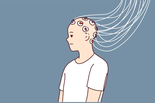 Man with electrodes connected to head to study brain activity and work of neurons or mind control
