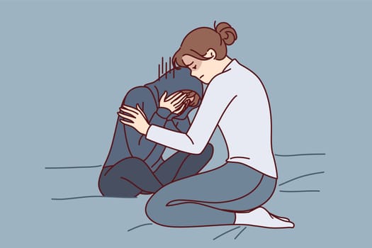 Mother consoles crying daughter who is depressed due to peer problems or poor school performance. Caring woman hugging and consoles crying girl after argument or house arrest related to bad behavior