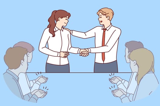 Handshake of boss and new employee of company during business meeting with colleagues. Man boss shakes hands with employee who has successfully completed complex project or attracted most customers