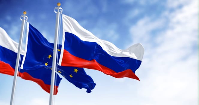 Russia and the European Union flags waving on a clear day. EU-Russia relations are strained due to Russia’s actions in Ukraine. 3d illustration render. Selective focus. Fluttering textile