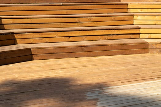 Wooden steps. Place for students to relax. Wooden benches. Scene details. Tribune for speeches. Empty seats.