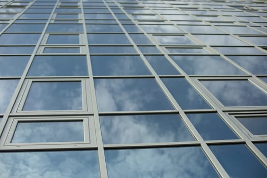 Mirror building. Reflection in windows. Modern architecture. Office building.