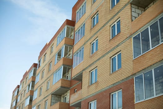 Building in city. Details of house. City architecture. Multi-family housing.