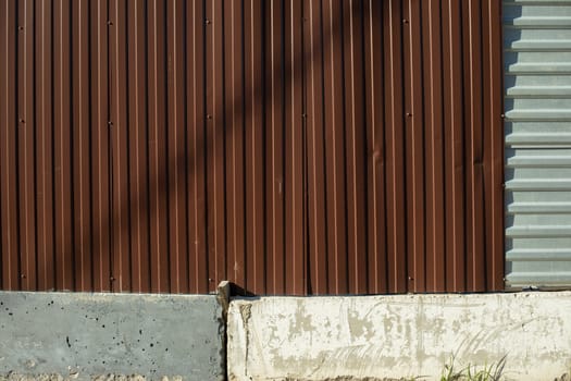 Fence around construction fence made of metal profile. Brown steel profile. Private territory.
