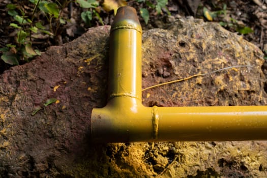 Yellow gas pipe. Pipes for communications. Steel part after painting. Industrial facility.
