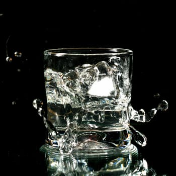 alcohol splash on black background close up