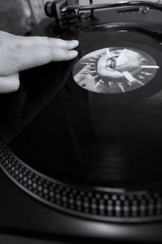 scratch of dj playing on his vinyls hand on