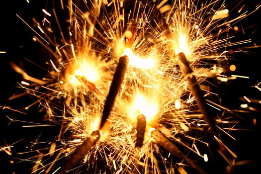 yellow sparkler holiday background on black