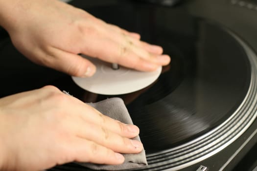 scratch battle of dj playing on his vinyls hand on