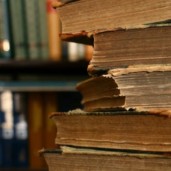 books on table in dark library room