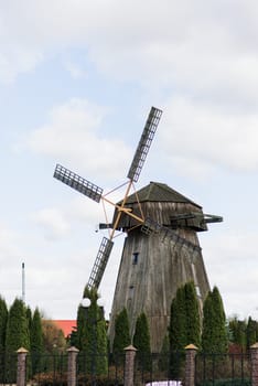 Old wooden wind mill in on sunny day. Old traditional Dutch mill.