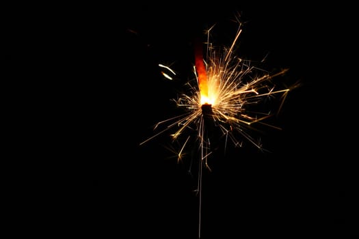 yellow sparkler holiday background on black