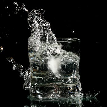 alcohol splash on black background close up