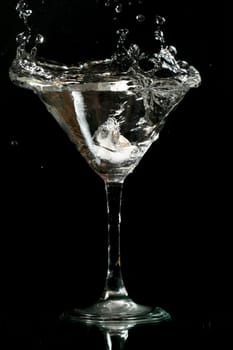 martini splash on black background close up
