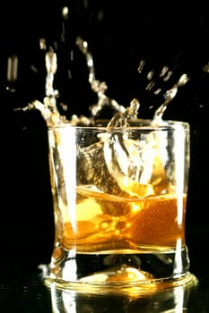 whiskey splash on black background