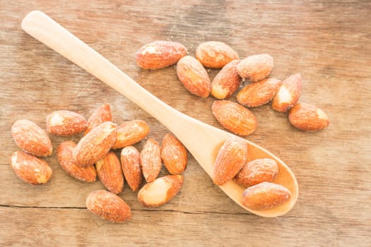 Almond grain roast salt on weathered wooden table, stock photo