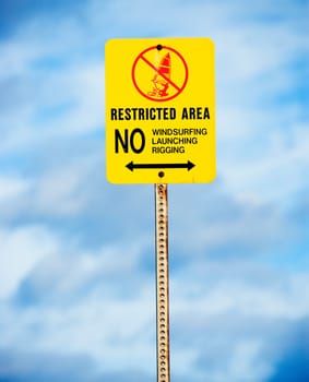 Sign near the ocean or lake warning of no windsurfing, rigging or launching.
