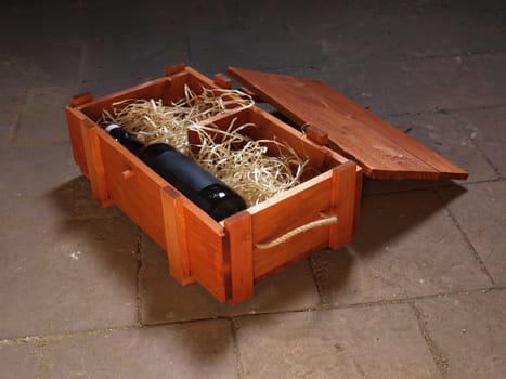 Old bottle of wine stored in wooden box