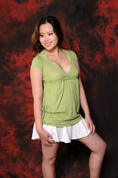 Pretty asian girl in a green blouse and white skirt