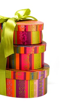 pyramid of colorful gift boxes with green bow on white background