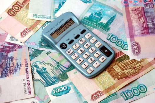 Much russian paper bills. On they lie the calculator.Symbolizes profit.