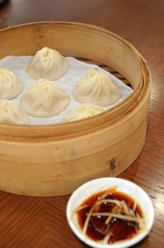 Shanghai soup dumplings served in bamboo steamer basket