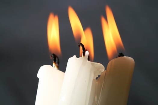 sacred candles in dark on black background