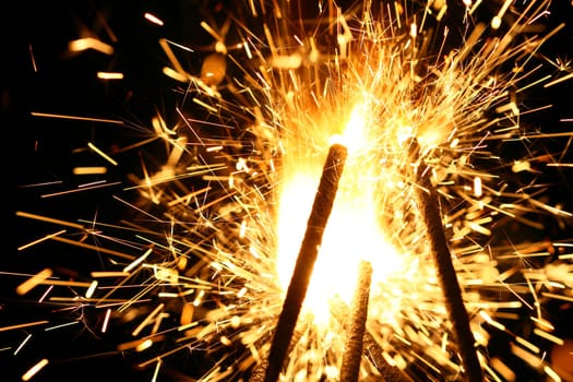 yellow sparkler holiday background on black