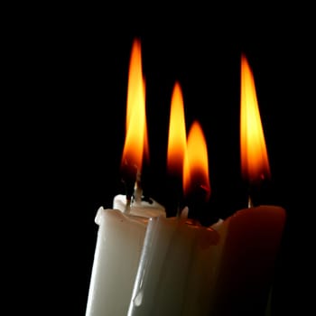 sacred candles in dark on black background