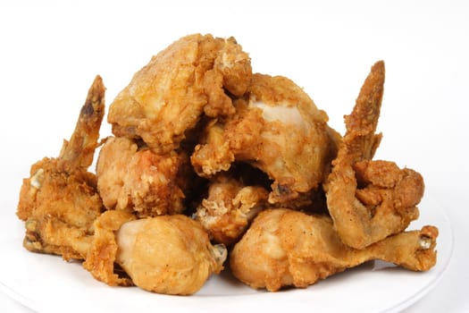 Pile of Crispy Golden brown fried chicken on a white background..battered, chicken, chicken wings, chicken legs, breast, thigh,crunchy,crispy,cuisine, .culinary, dinner, fast food, fried, fried chicken, golden brown,lunch,poultry, pollo,.white background