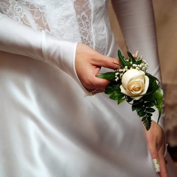 Rose in hand of bride. Wedding gloves