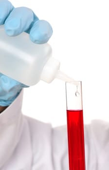 Test tube and dropper bottle with liquid.