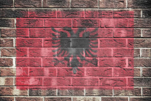An Albania flag on a brick wall background