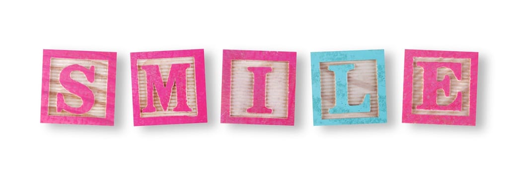 A smile concept with childs wood blocks on white with clipping path to remove shadow