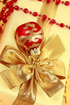 Christmas present with ball in golden and red tone
