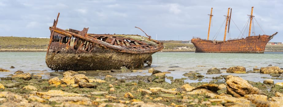 An old whaler wreck in Whalebone Cove off Stanley in the Falkland Islands. Stanley in the background