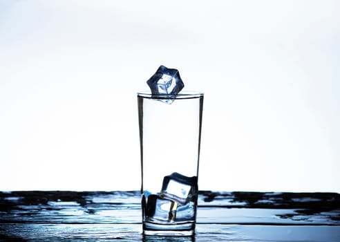 The image of pouring drinking water, into a glass, that makes one feel refreshed on blurred white background, Splashing water, Sparkling water