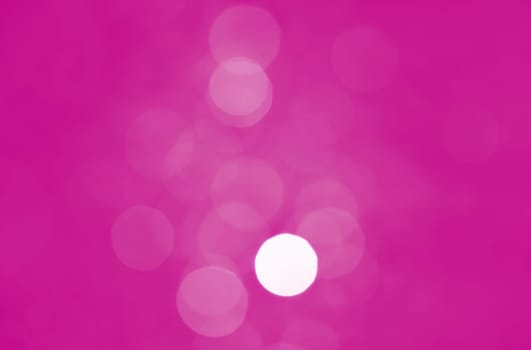 Light abstract pink bokeh christmas circle color glitter blurred black background