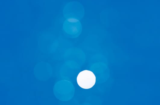 Light abstract blue bokeh christmas circle color glitter blurred black background