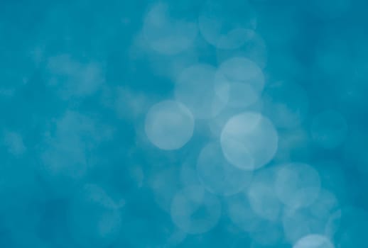 Light abstract blue bokeh christmas circle color glitter blurred black background