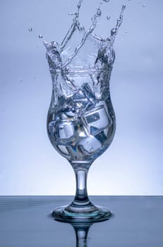 The image of pouring drinking water, into a glass, that makes one feel refreshed on blurred white background, Splashing water, Sparkling water