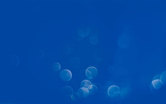 Light abstract blue bokeh christmas circle color glitter blurred black background