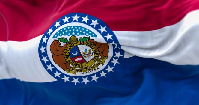 Close-up of the Missouri state flag waving. Red, white, blue horizontal stripes with Great Seal of Missouri in center. 3d illustration render. Textured background. Selective focus. Fluttering textile