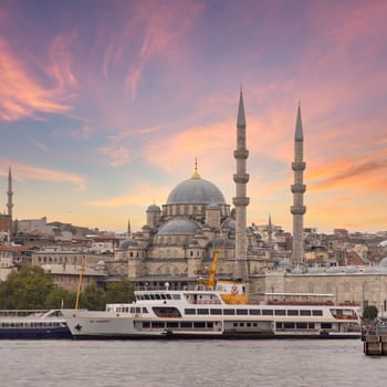 Istanbul city view from Galata Bridge at Eminonu overlooking the Golden Horn with ferries, ferry terminals, and Rustem Pasha Mosque before sunset, Istanbul, Turkey