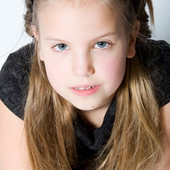 Studio portrait of a blond child making eye contact