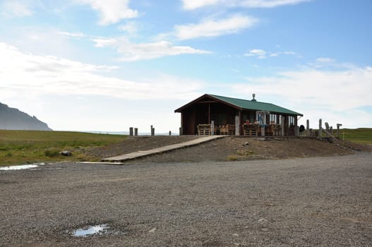 View of a house in a field on a beautiful day in Iceland