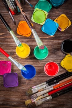 Different used brushes, colours and watercolours