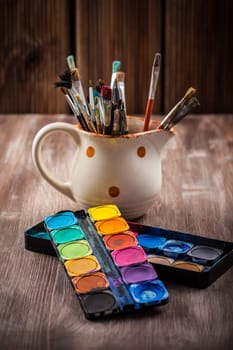 Different used brushes, colours and watercolours
